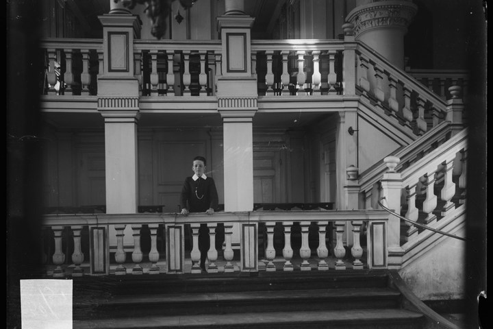 Glasnegatief van foto van producten uit de Cuypers' Kunstwerkplaatsen: "Foto van een jongen in een trappenhuis".